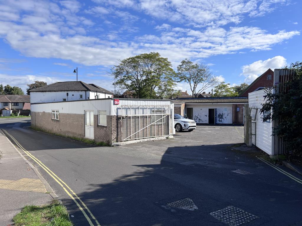 Lot: 91 - FREEHOLD DEVELOPMENT SITE - Rear entrance to car park with metal gates